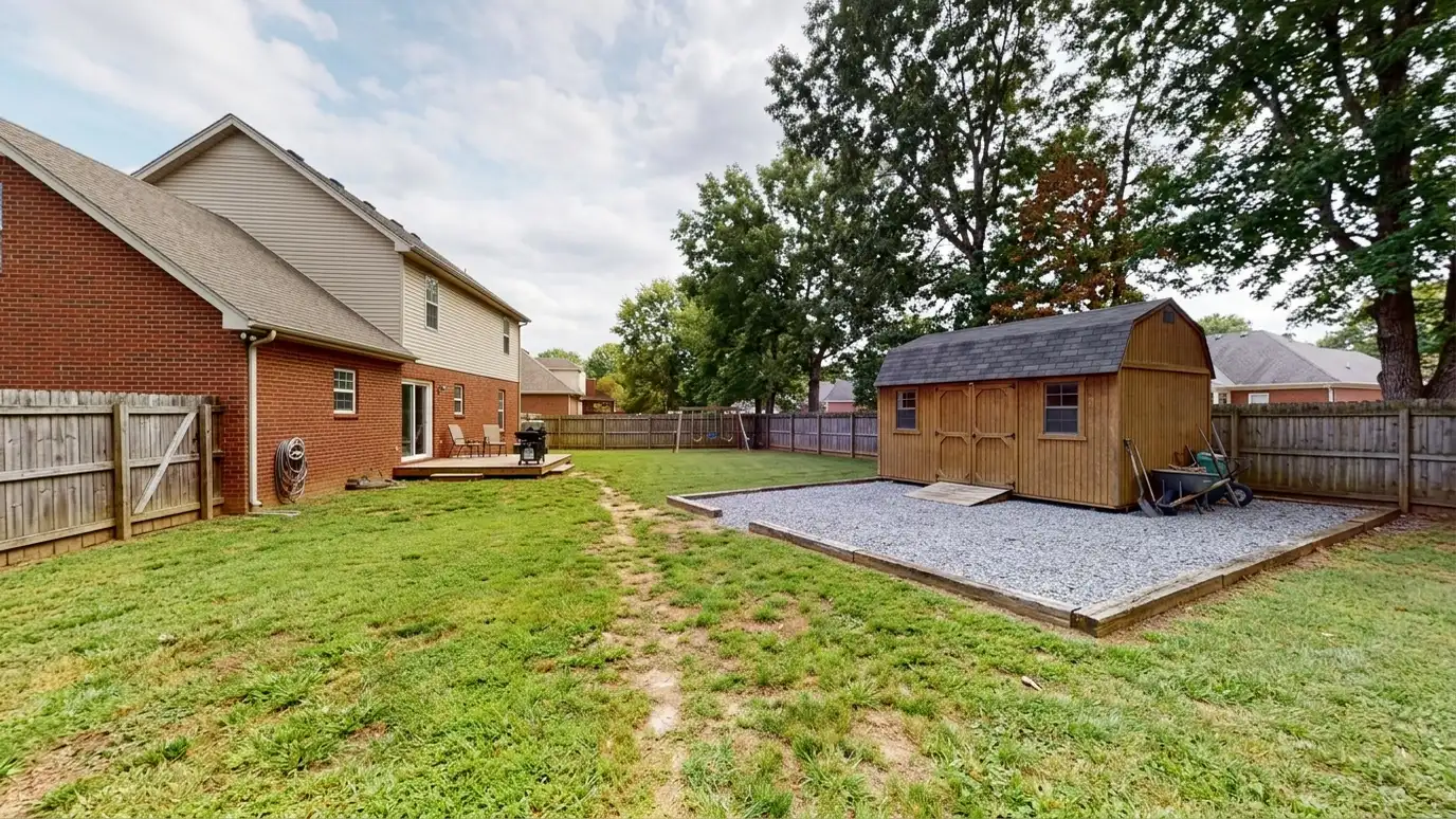 A La Vergne, Tennessee home with a neat custom shed, a carport and a detached garage in a landscaped yard