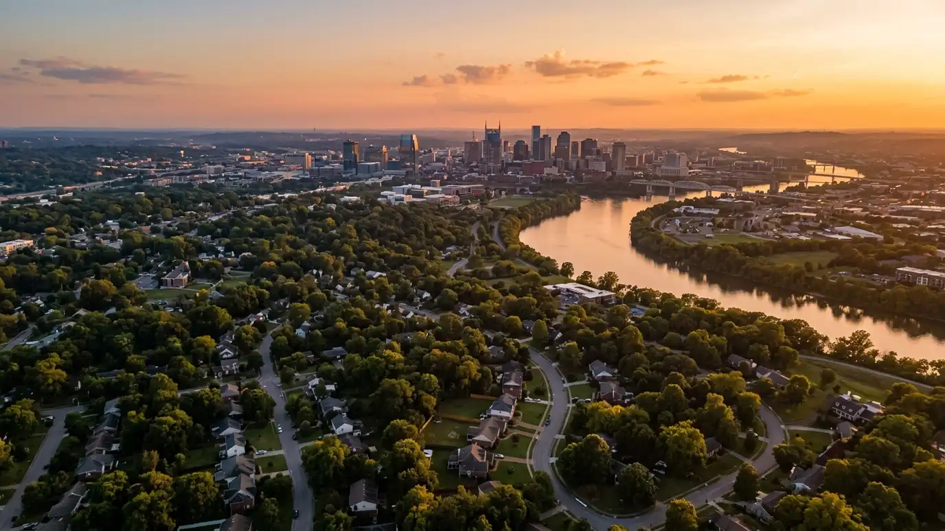 Shed, garage and carport service areas | Nashville and Middle Tennessee A golden sunset aerial view of the Nashville skyline above tree-covered neighborhoods with suburban homes and a winding river, warm evening light